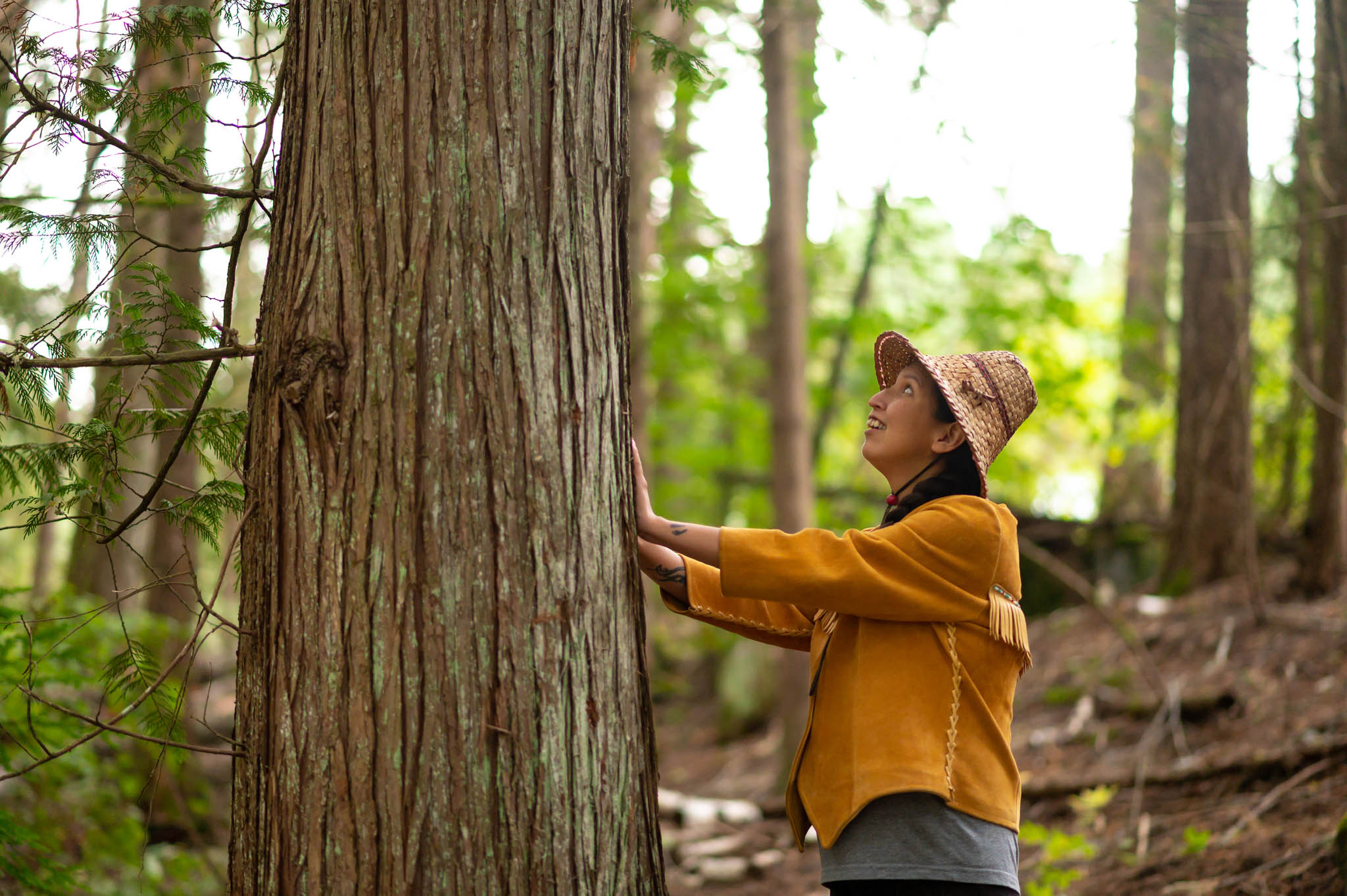 First Nations woman blessing a cedar tree